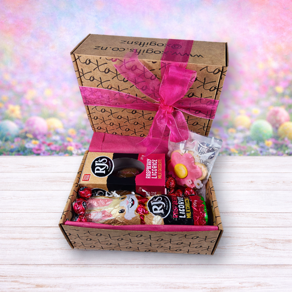 Gift box with candies and a pink bow on a colorful blurred background
