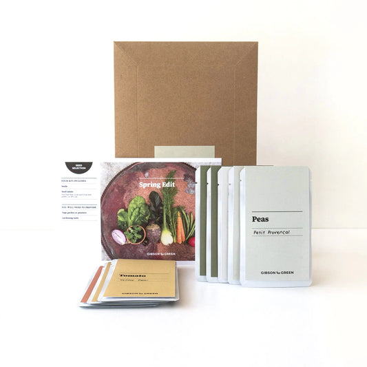 Garden kit with seed packets and a cardboard box on a white background