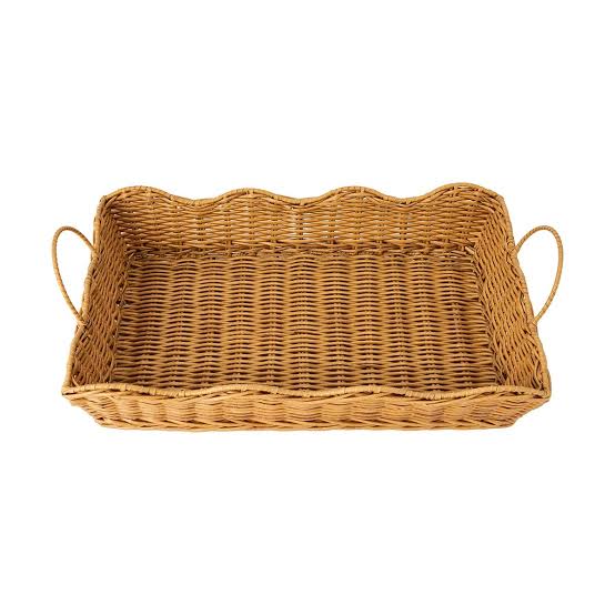 Wicker basket with handles on a white background
