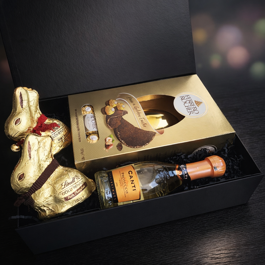 Gift set with Lindt gold bunny, Ferrero chocolate box, and Canti bottle in a black box.
