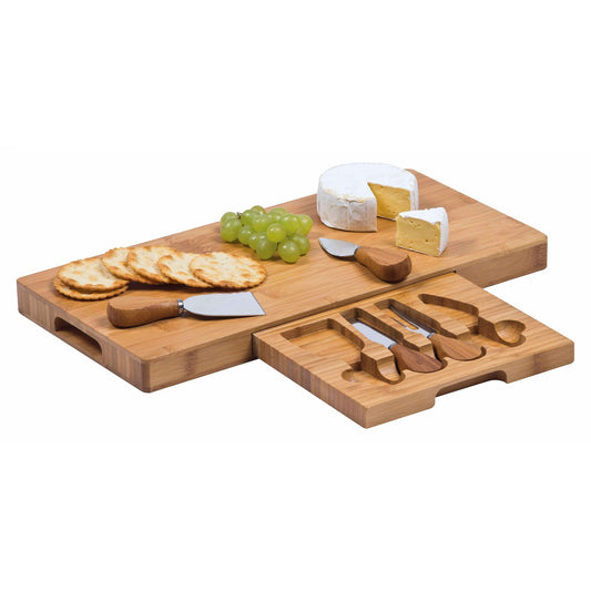 A bamboo cheese board set with retractable drawer, displaying stainless steel bamboo utensils and cheese knives, alongside crackers and grapes.