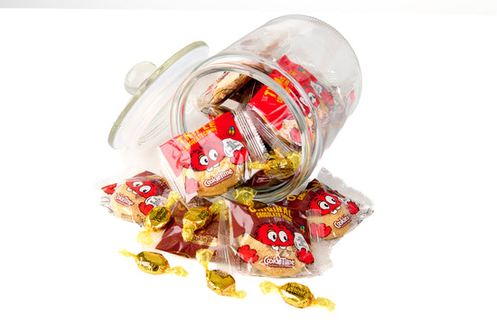 Jar of candy with red and yellow packages on a white background