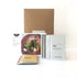 Garden kit with seed packets and a cardboard box on a white background