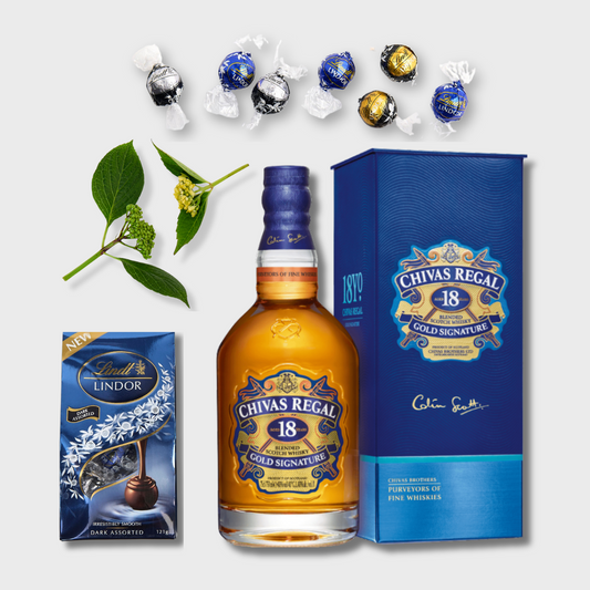 Chivas Regal 18 whiskey bottle with Lindor truffles and packaging on a white background