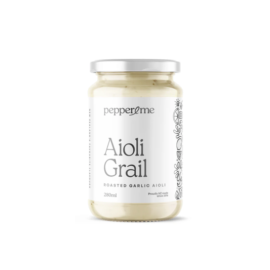 A glass jar of PepperZme Aioli Grail roasted garlic aioli, featuring a white label with black text and a silver metal lid, set against a plain white background.