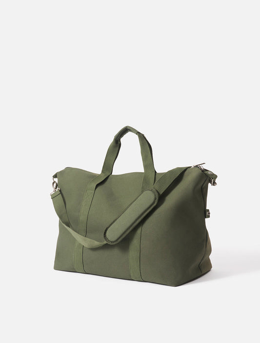 A green weekender bag with a zipper closure and a strap.